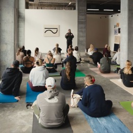 a group of people sitting in a yoga class