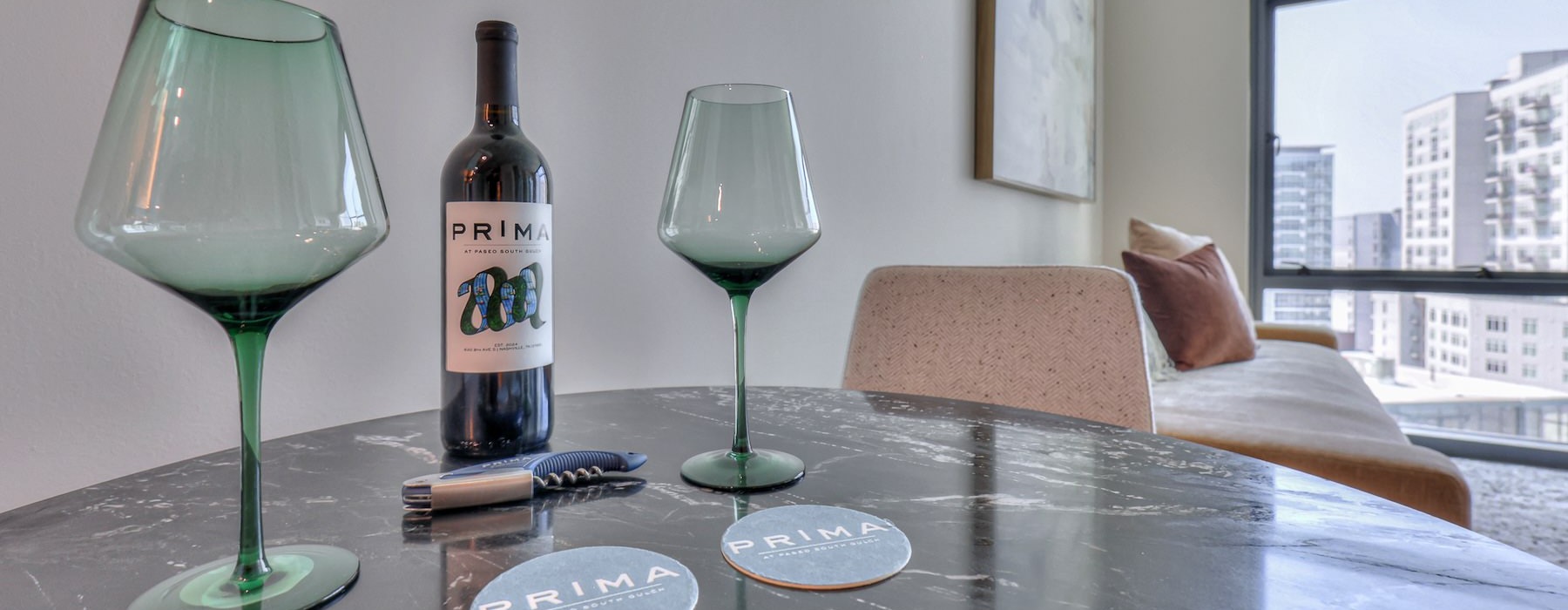 a table with wine glasses and a bottle of wine on it