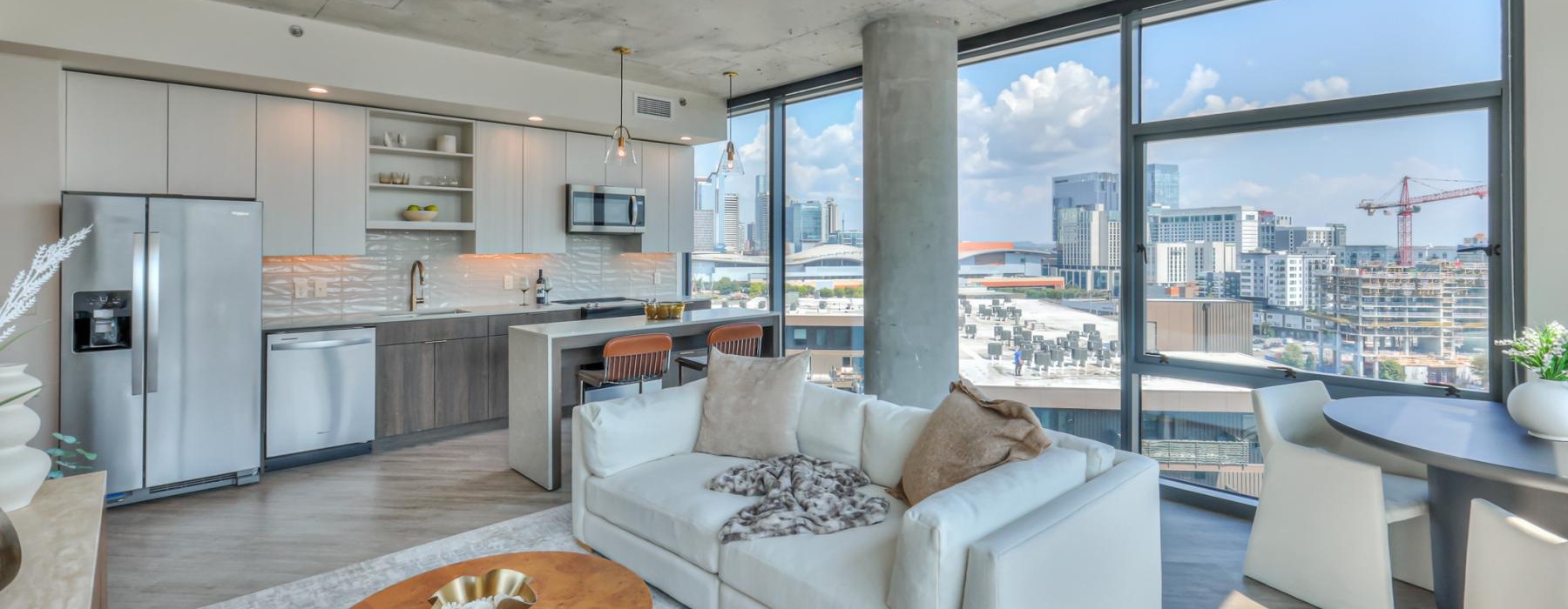 a living room with a couch, tables and chairs