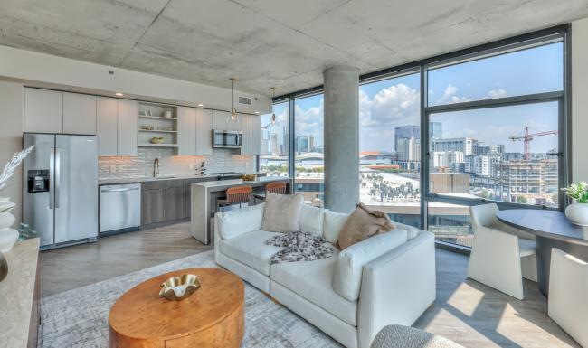 a living room with a couch, tables and chairs